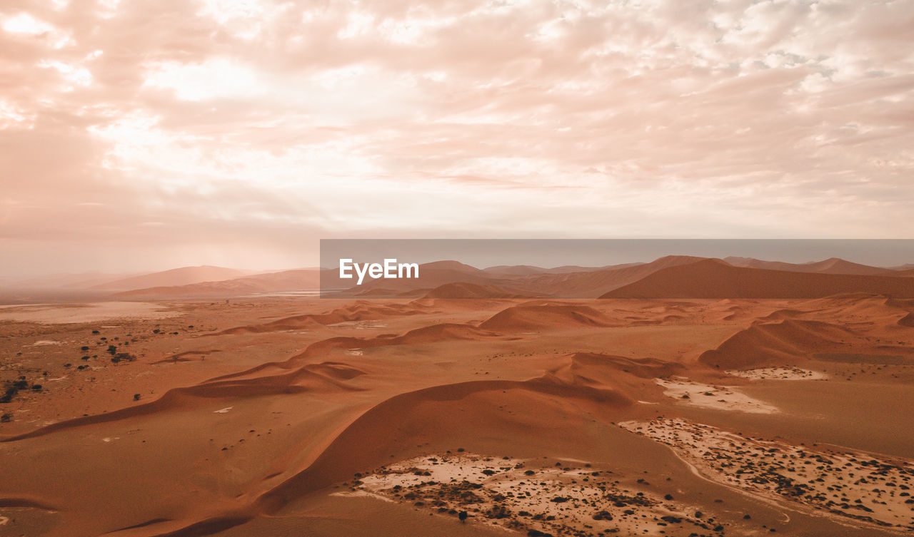 Scenic view of landscape against cloudy sky