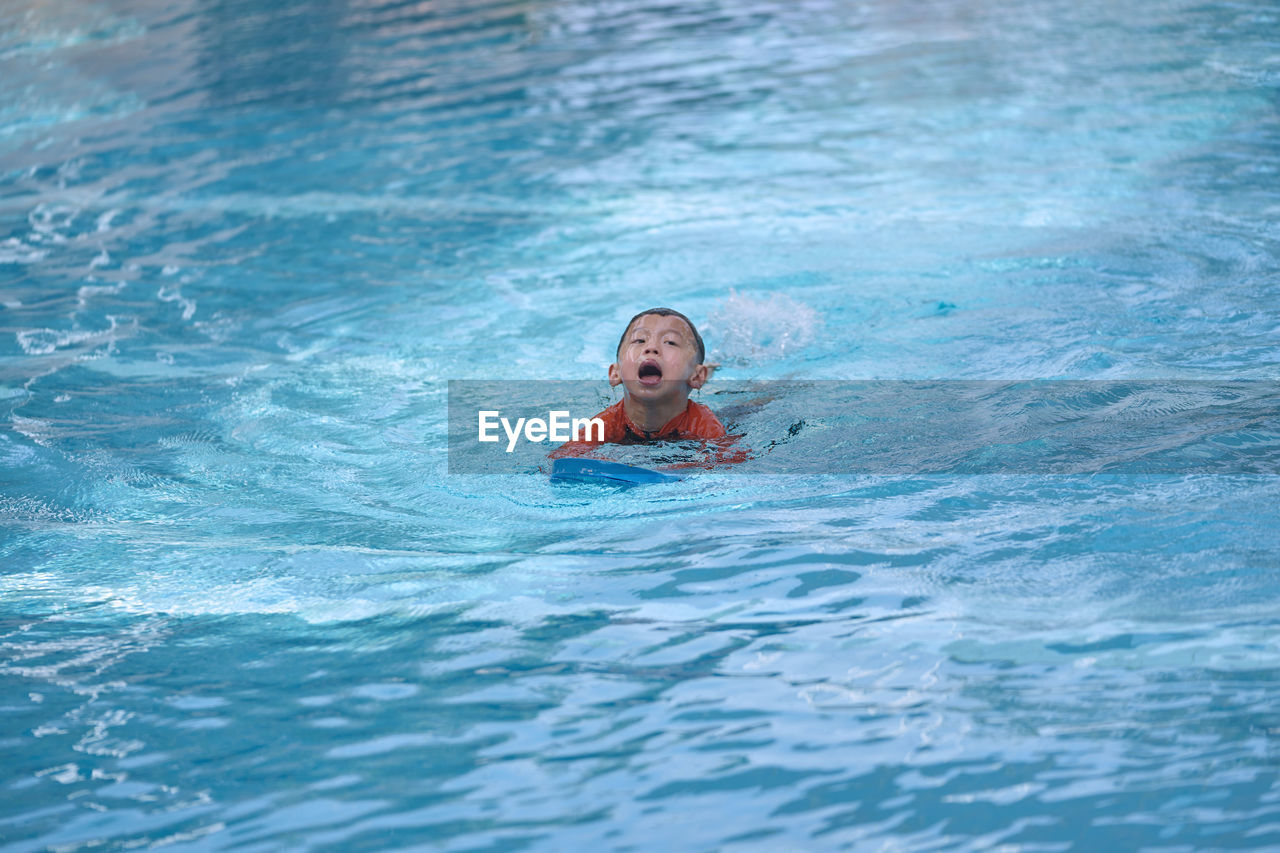 Boy swimming in pool