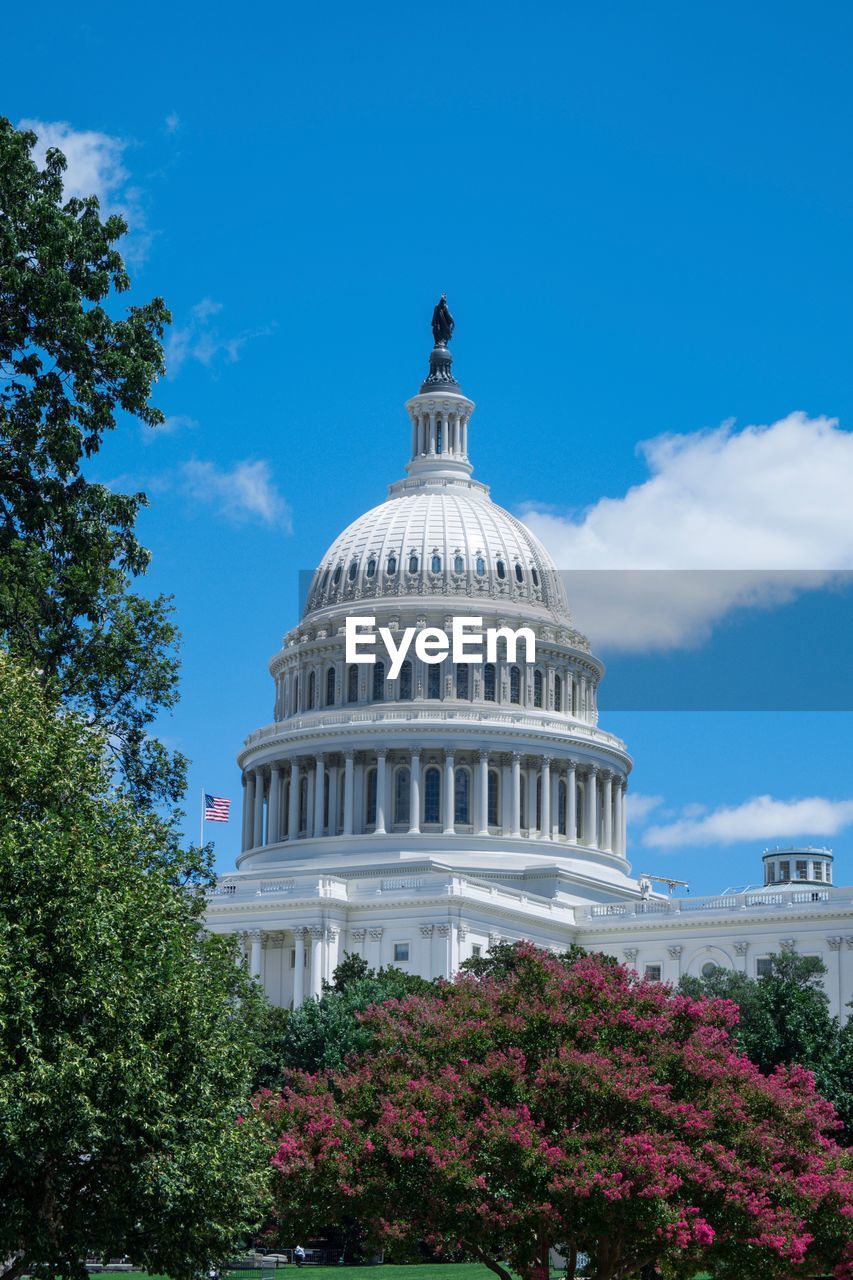 Capitol building against cloudy sky