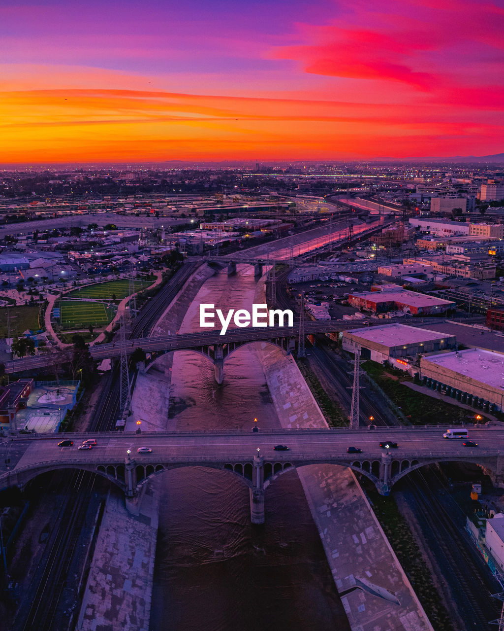 high angle view of illuminated cityscape during sunset