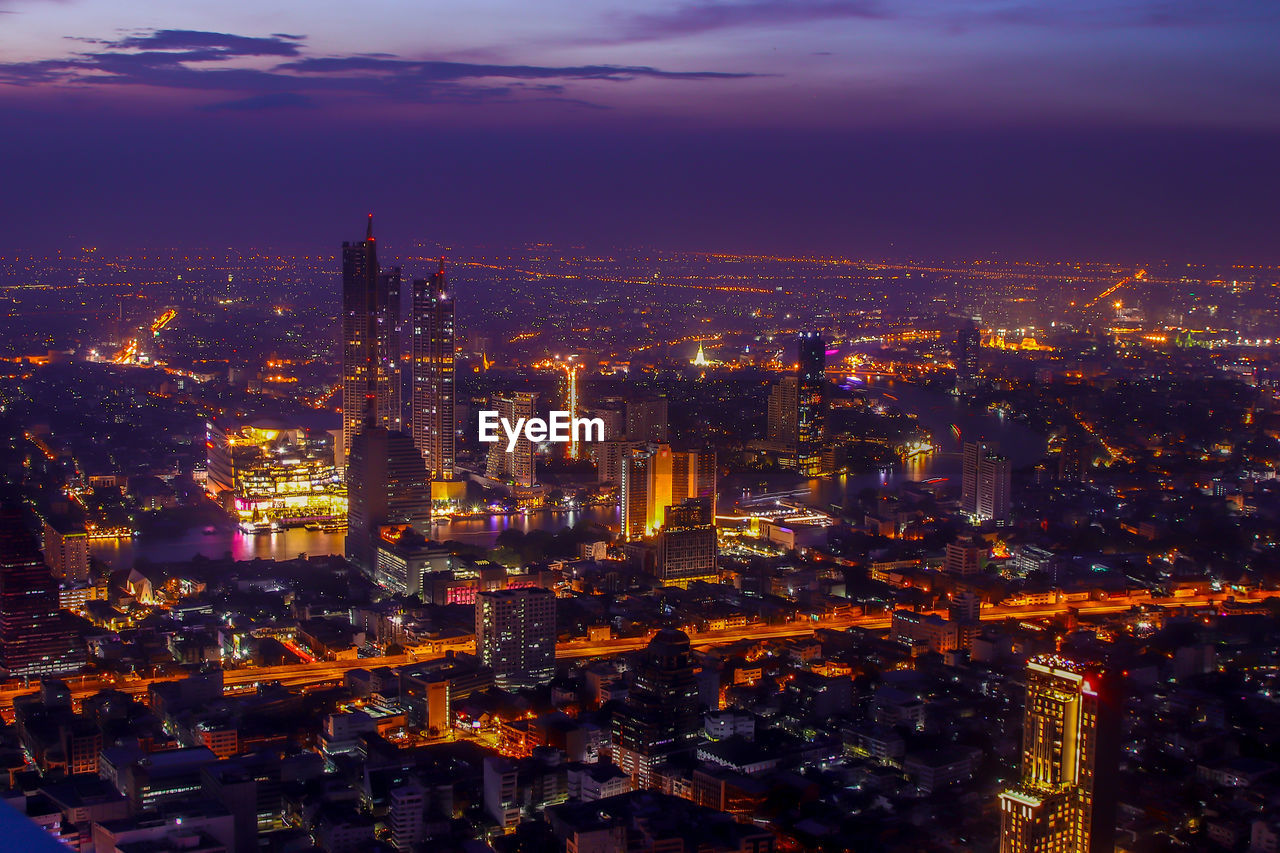 Aerial view of illuminated buildings in city at night