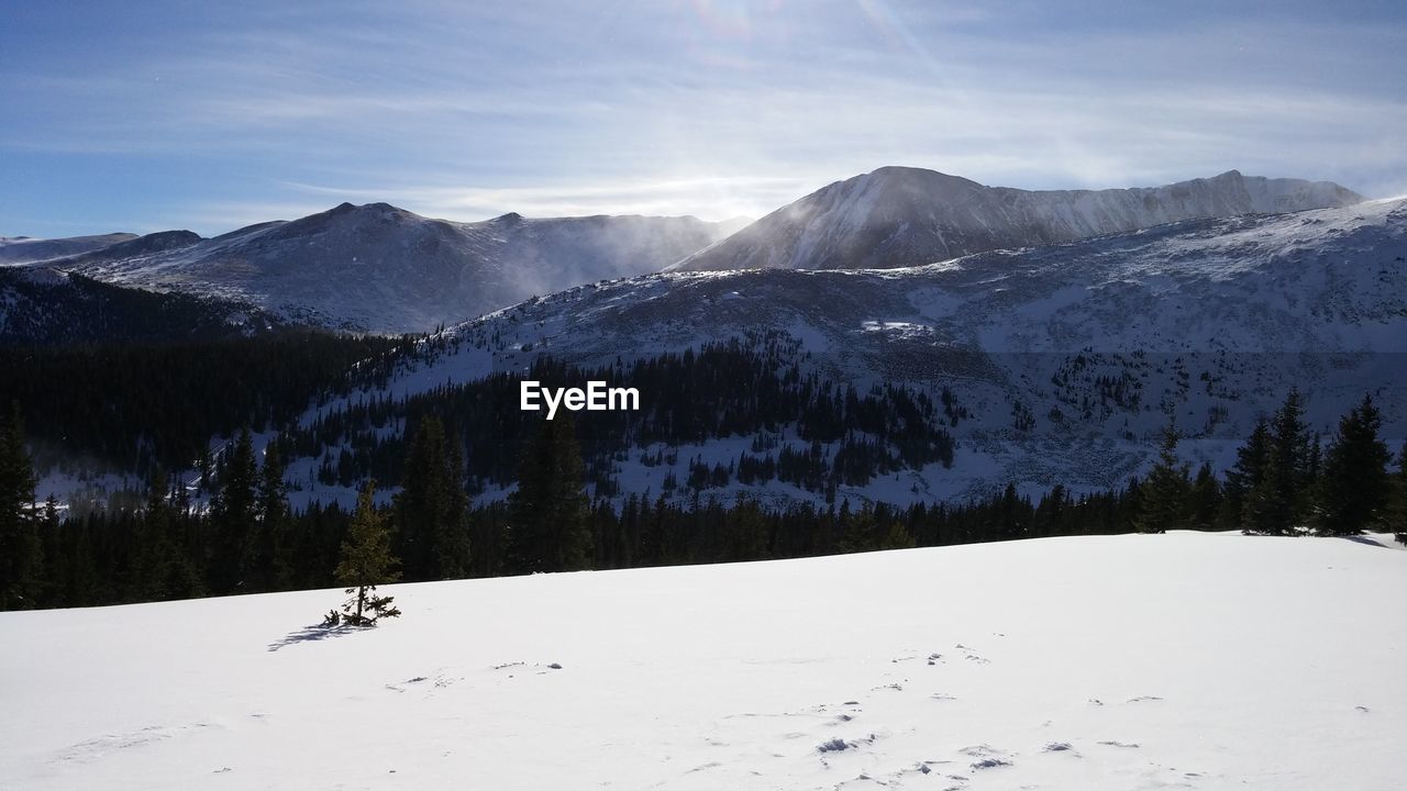 Scenic view of snow covered mountains against sky