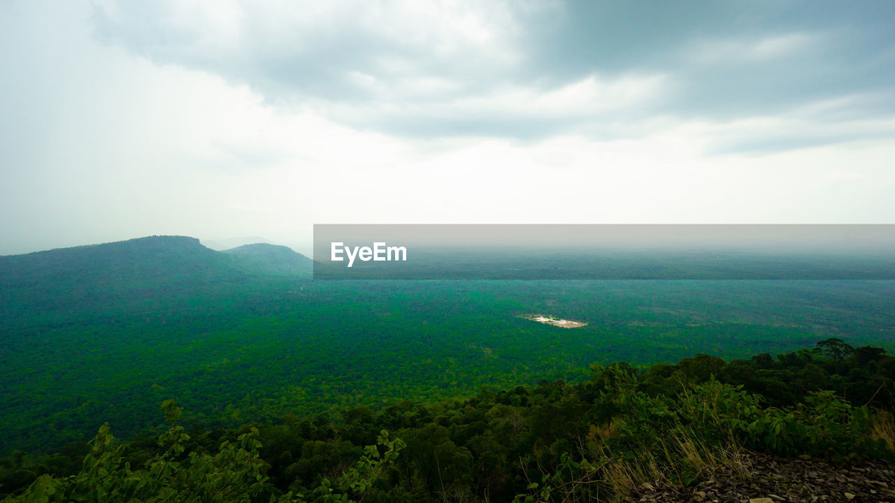 SCENIC VIEW OF GREEN LANDSCAPE AND MOUNTAINS AGAINST SKY