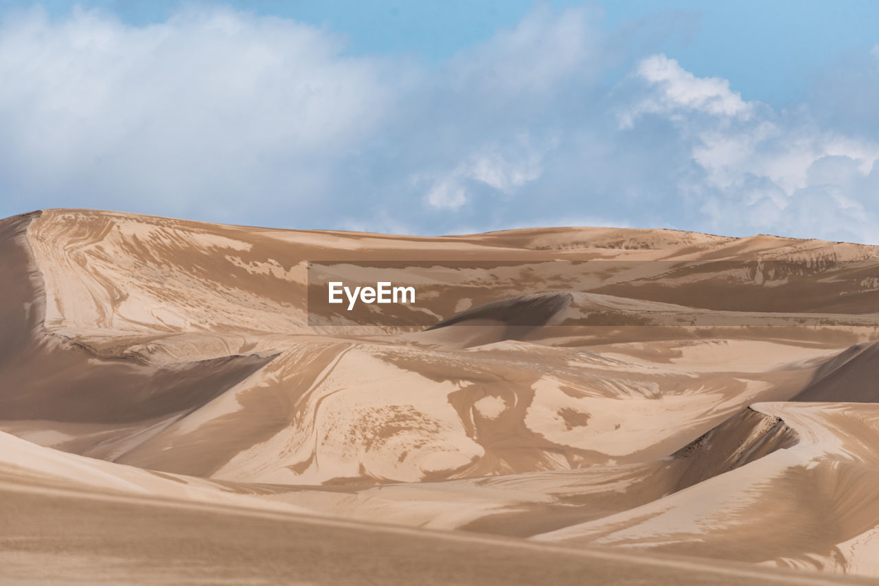 View from nature and landscapes of dasht e lut or sahara desert after the rain with wet sand dunes