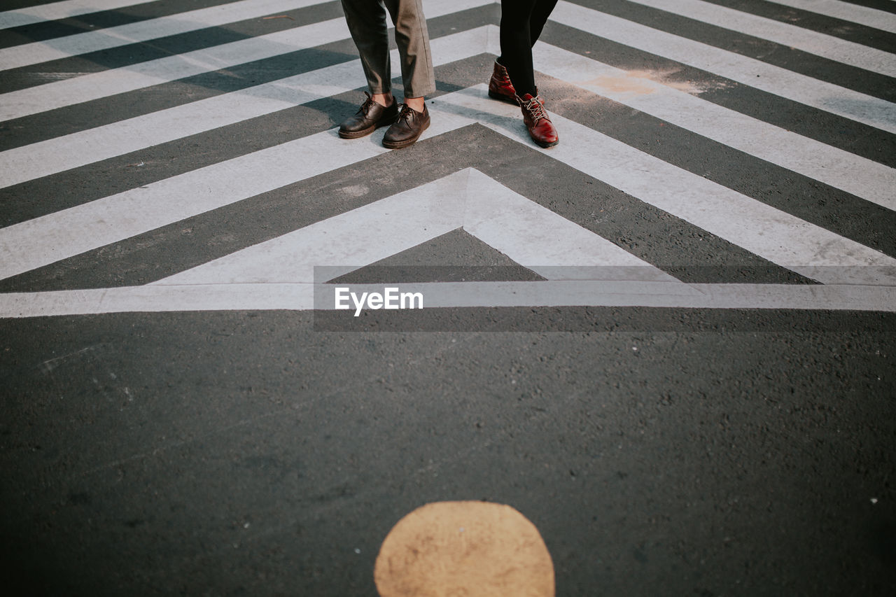 Low section of men on zebra crossing