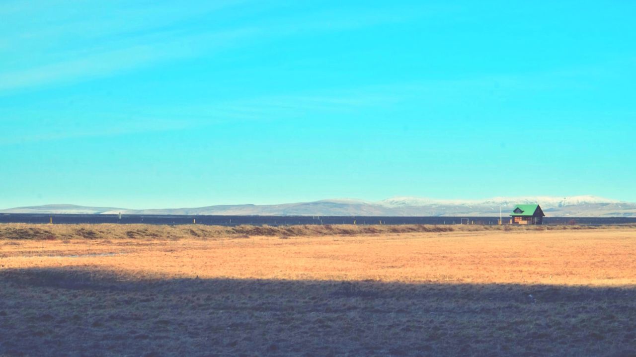 Scenic view of landscape against blue sky
