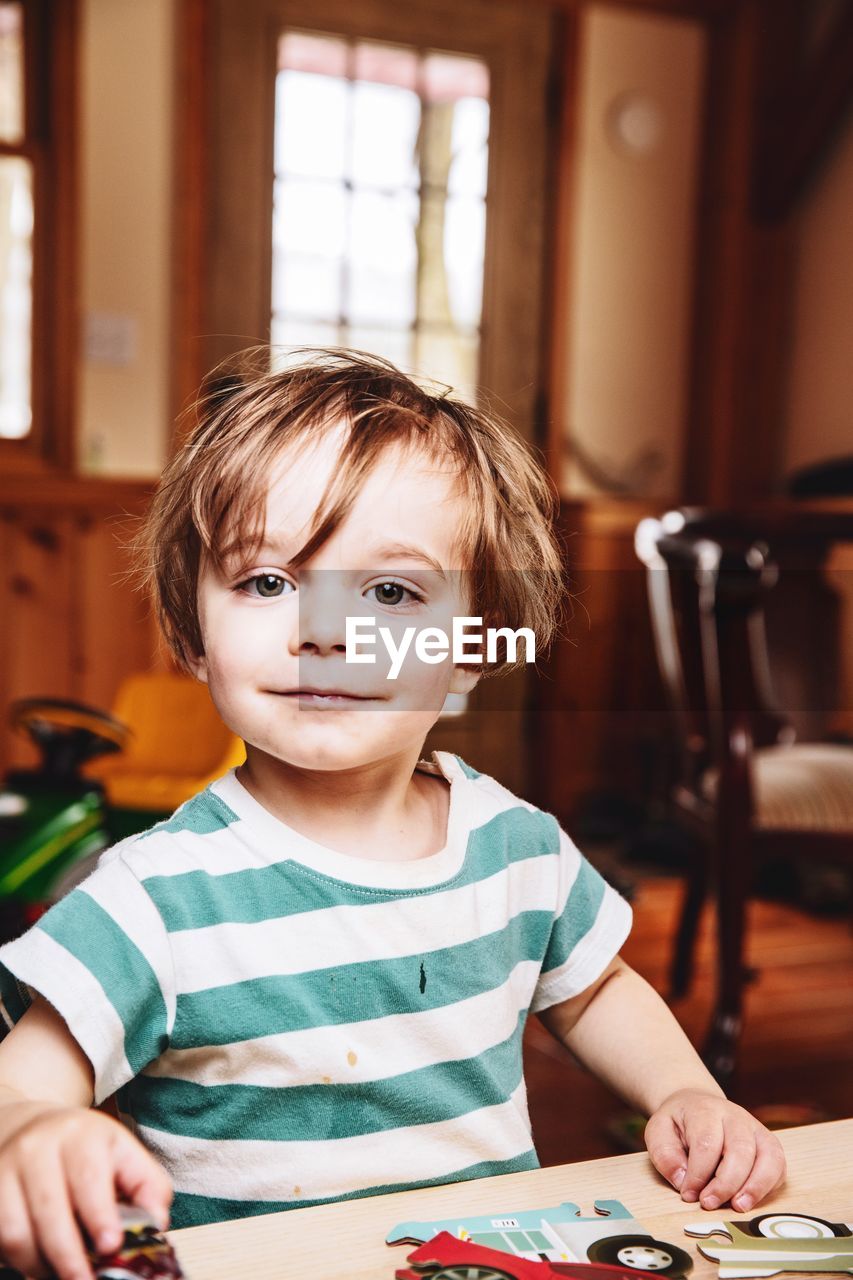 Portrait of innocent boy sitting at home