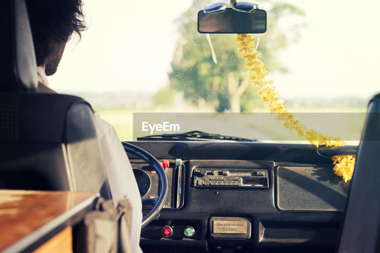 Cropped image of man driving car