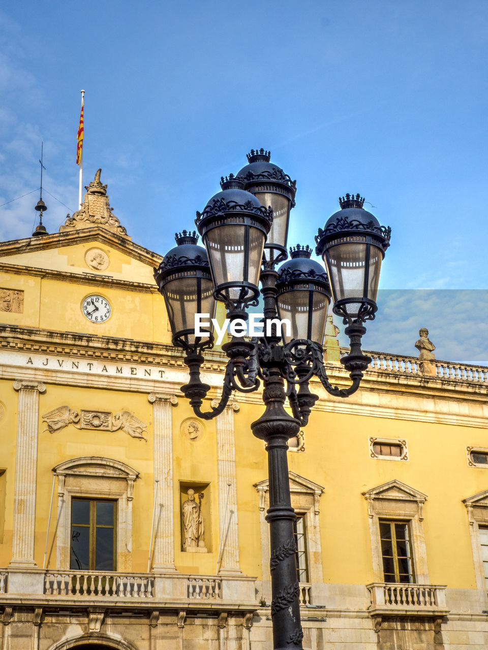 Low angle view of ajuntament de tarragona and street light against sky