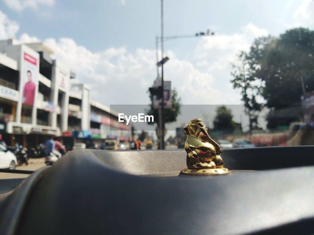CLOSE-UP OF FIGURINE ON TABLE BY CAR