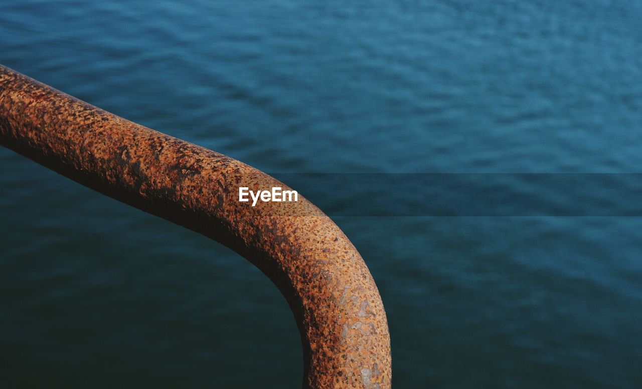 High angle view of rusty railing against river