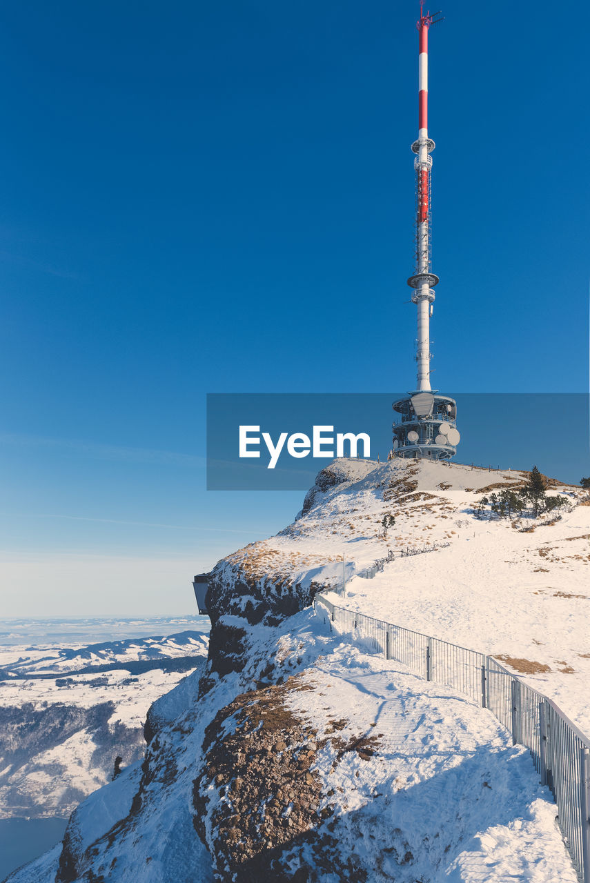 TOWER ON SNOWCAPPED MOUNTAIN AGAINST SKY