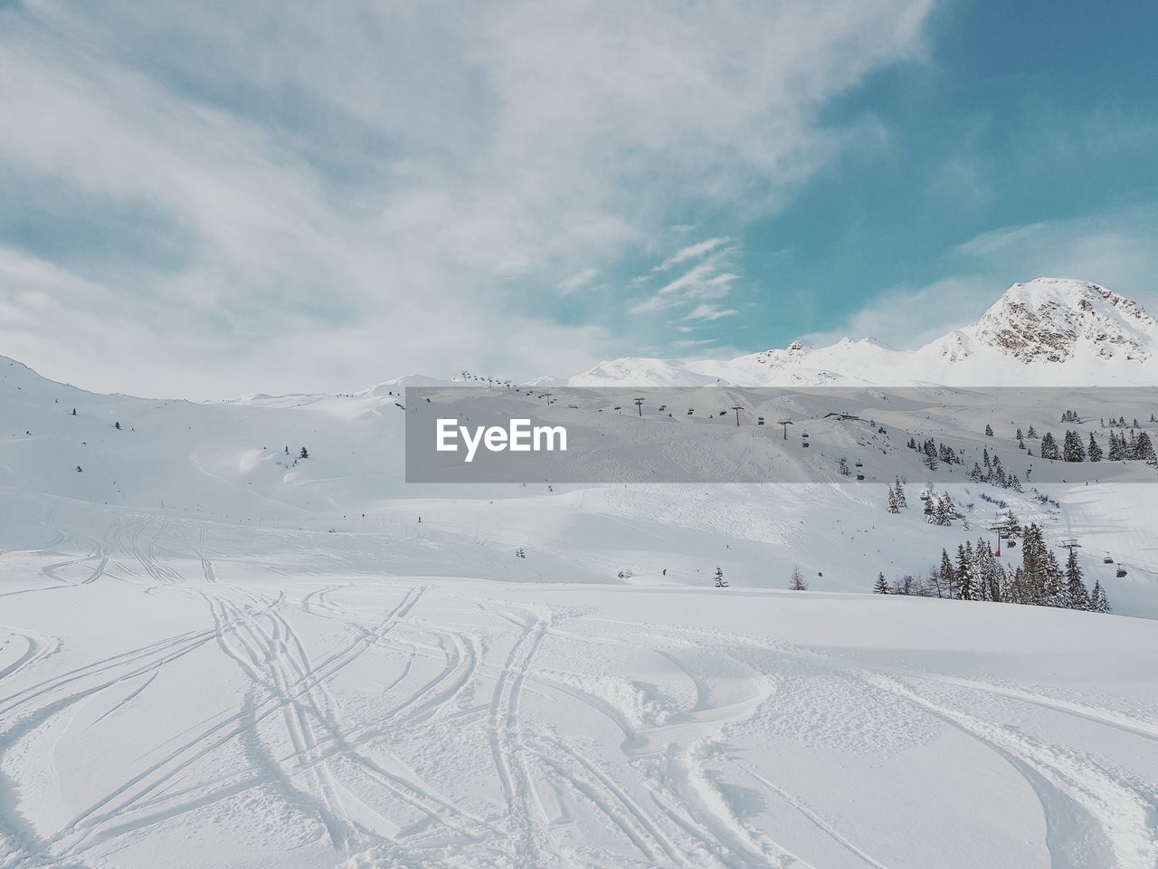 SNOW COVERED MOUNTAINS AGAINST SKY