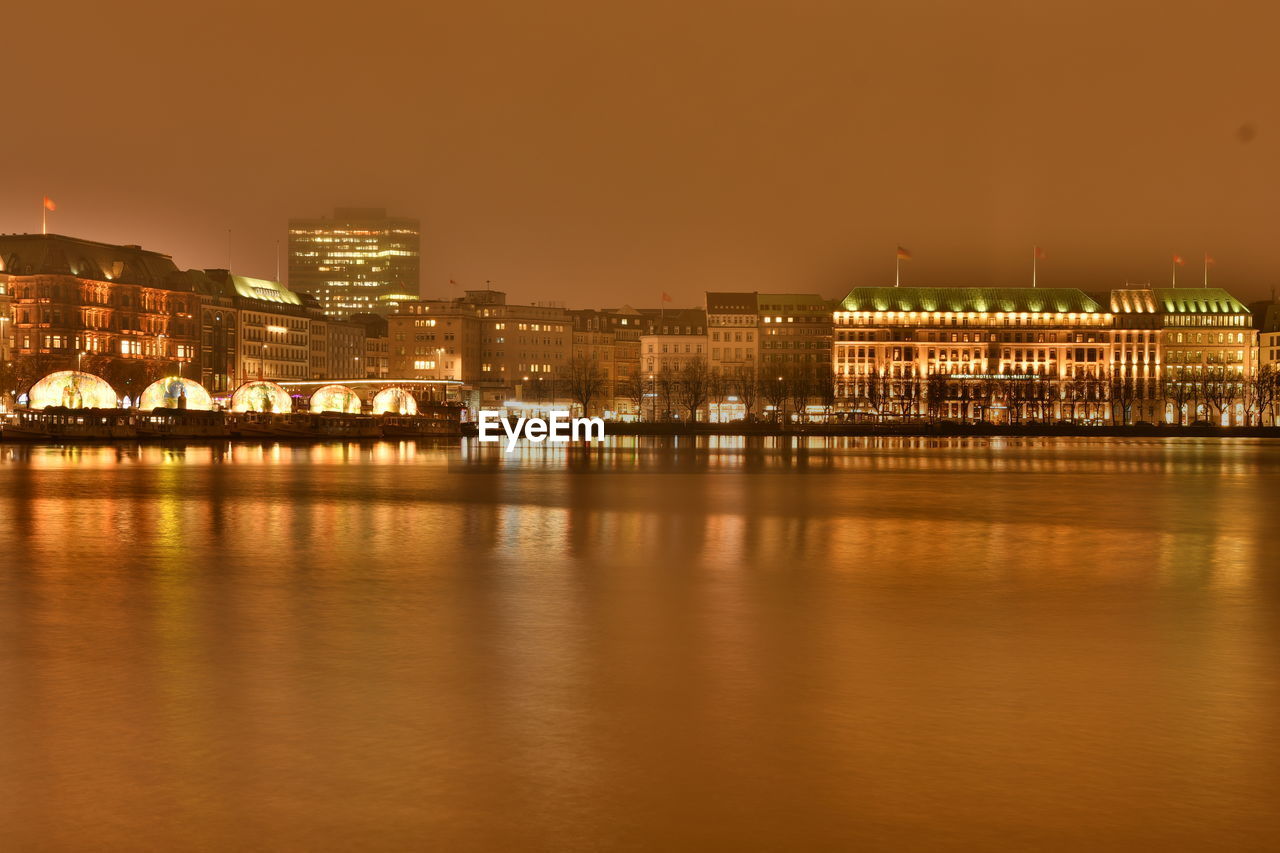 Illuminated city at waterfront