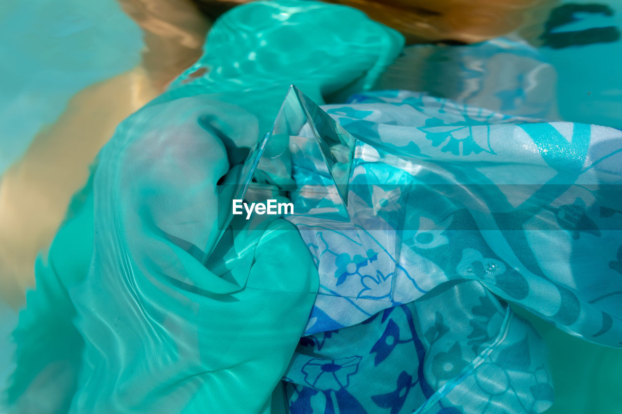 High angle view of pyramid crystal on fabric in swimming pool