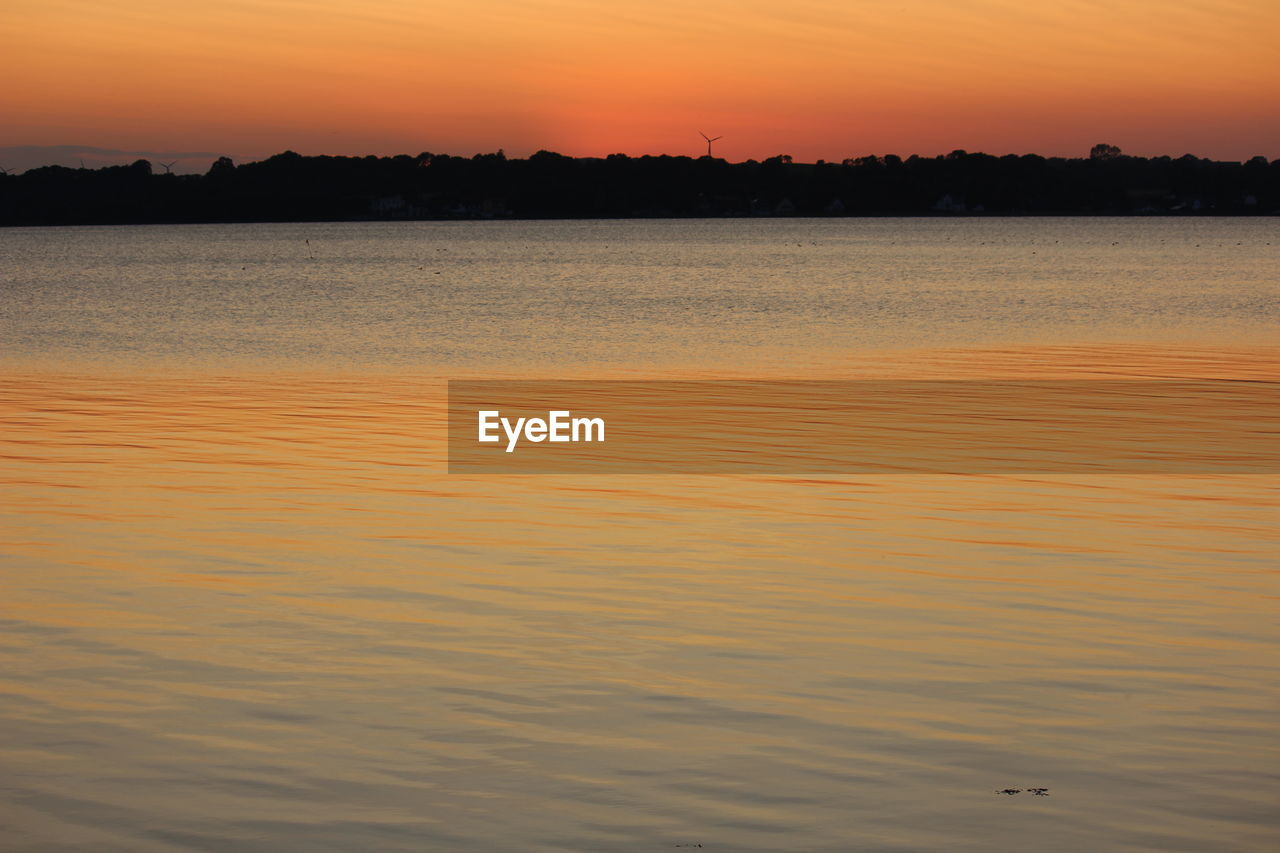 Scenic view of sea against romantic sky during sunset