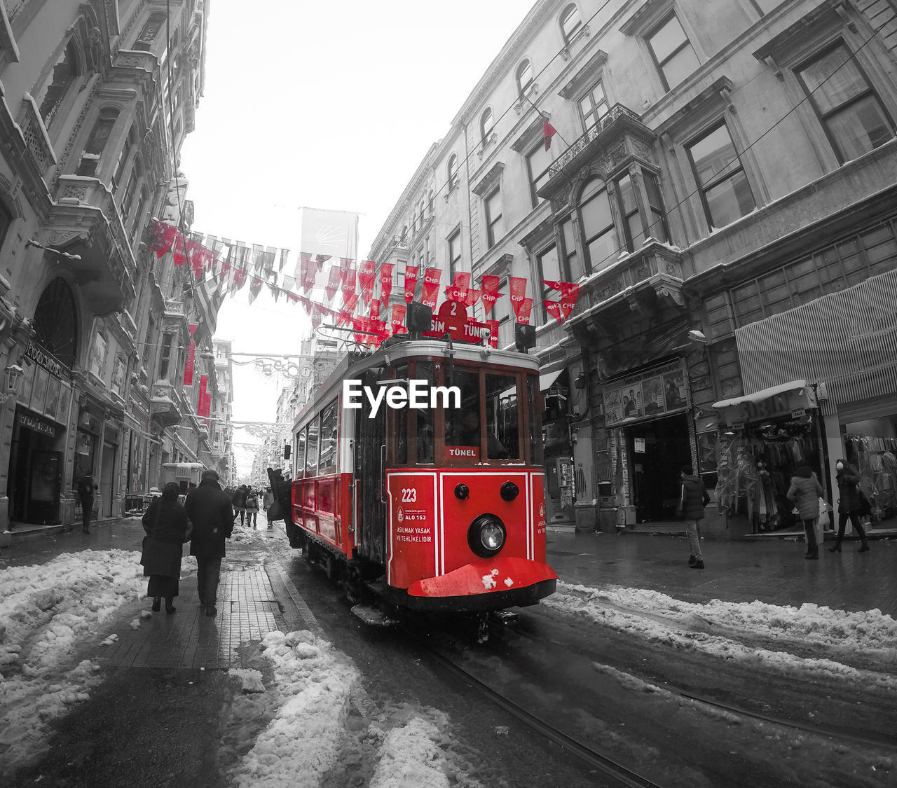 RED CAR ON STREET IN CITY