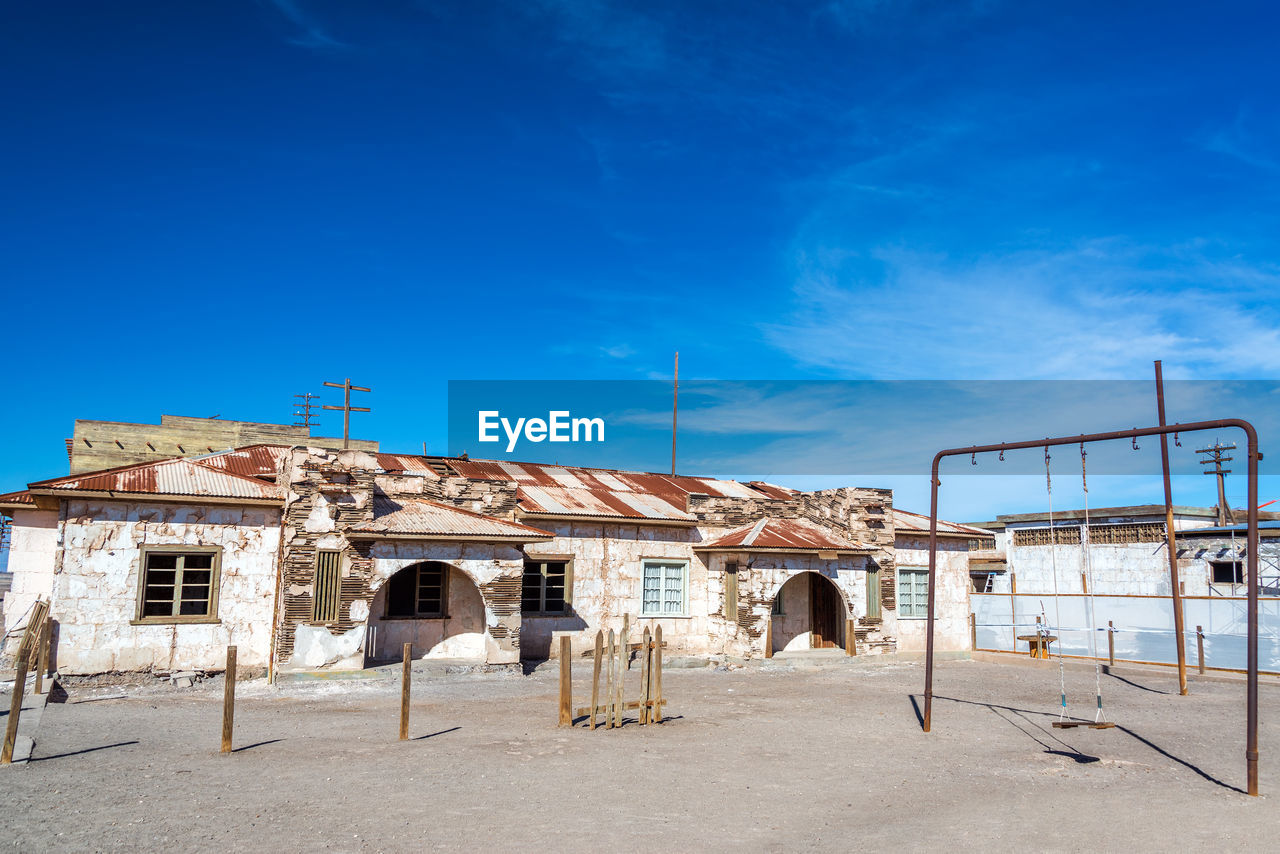 Exterior of abandoned house against sky