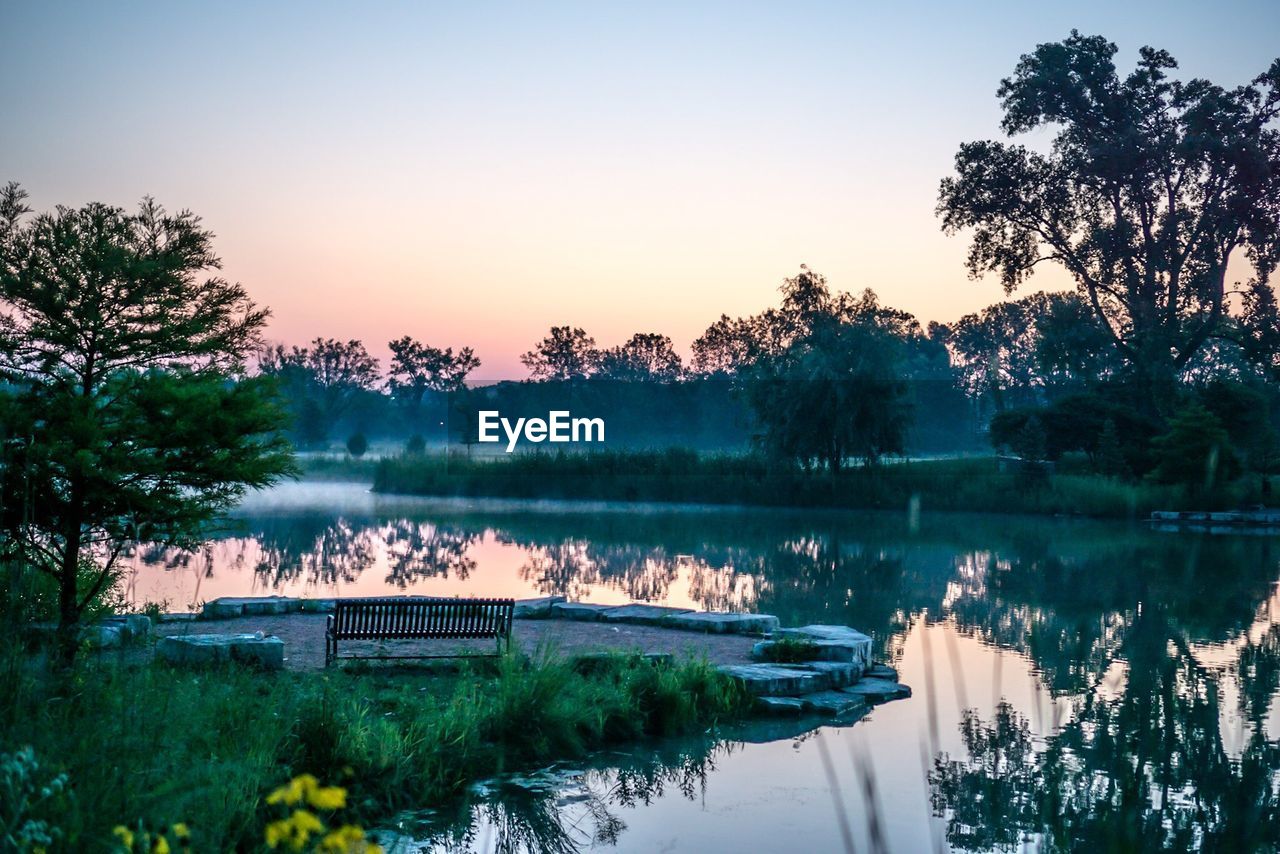 Scenic view of river against clear sky during sunset