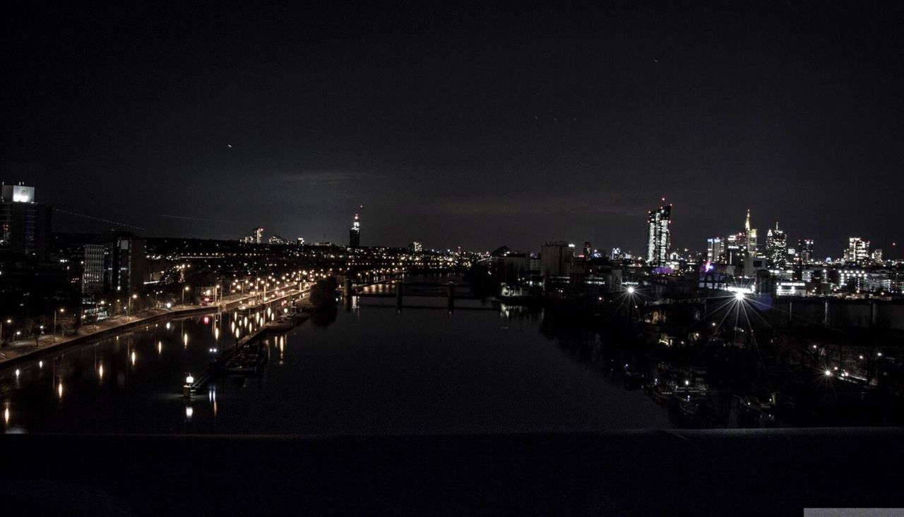 VIEW OF ILLUMINATED CITYSCAPE AT NIGHT