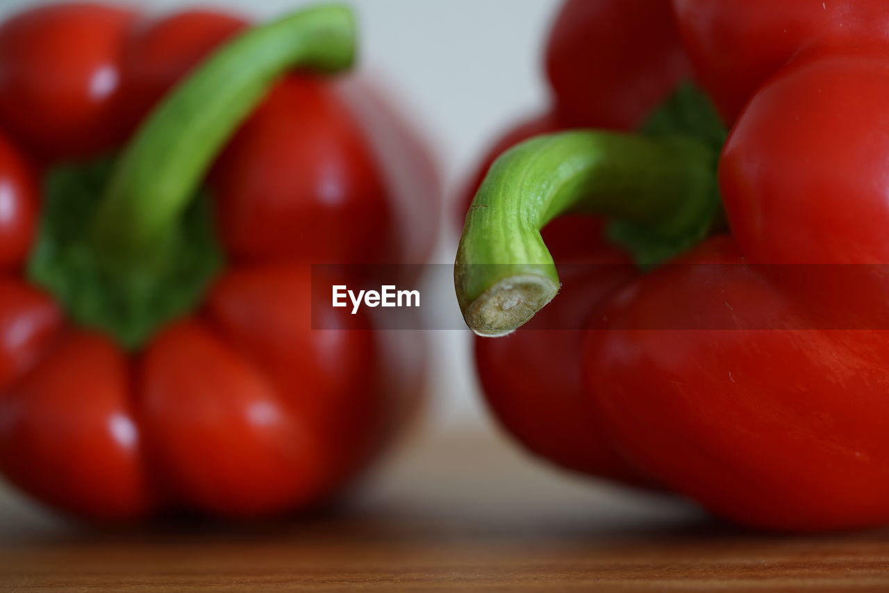 CLOSE-UP OF RED CHILI PEPPERS AND VEGETABLES ON TABLE