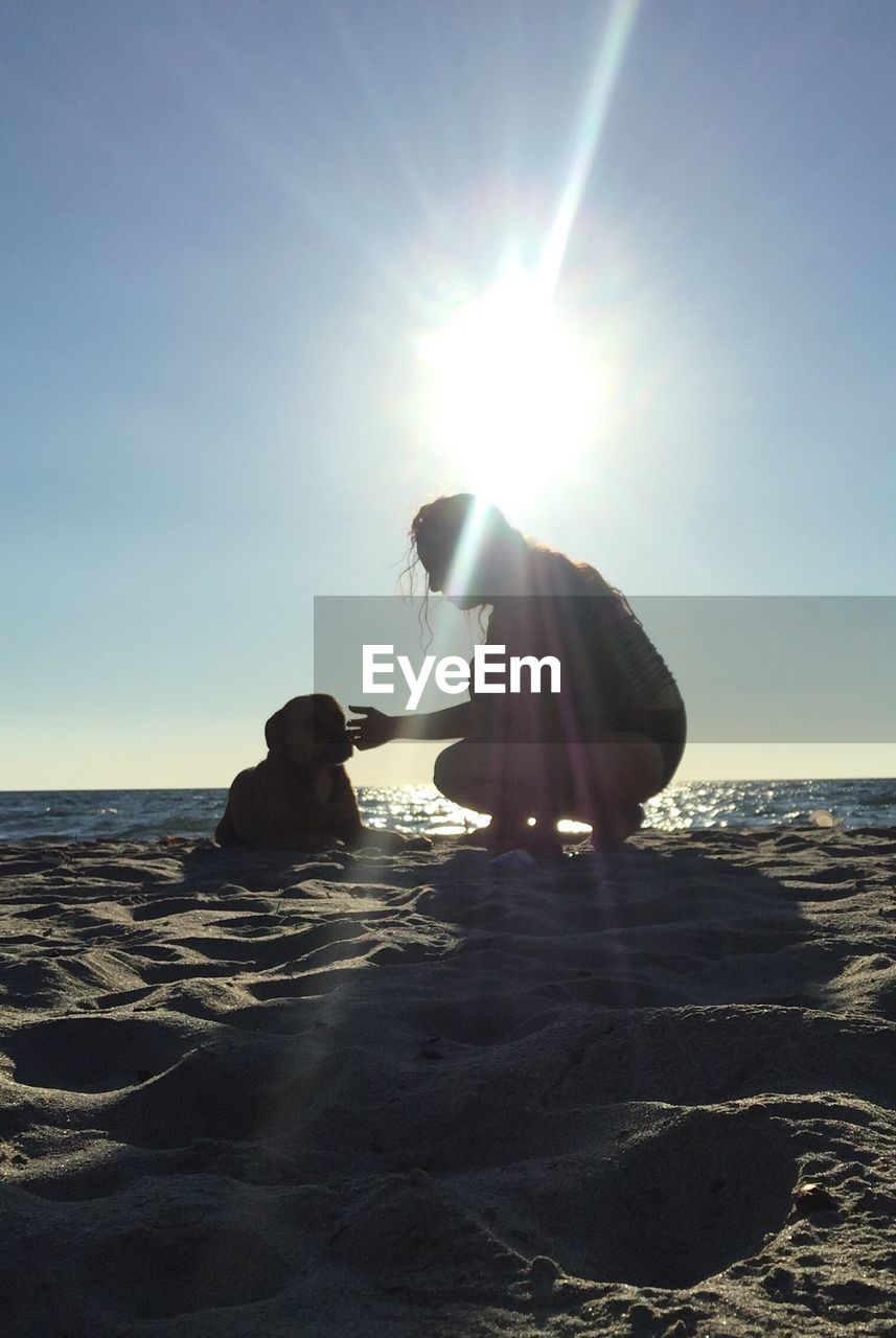 PEOPLE ON BEACH AGAINST CLEAR SKY