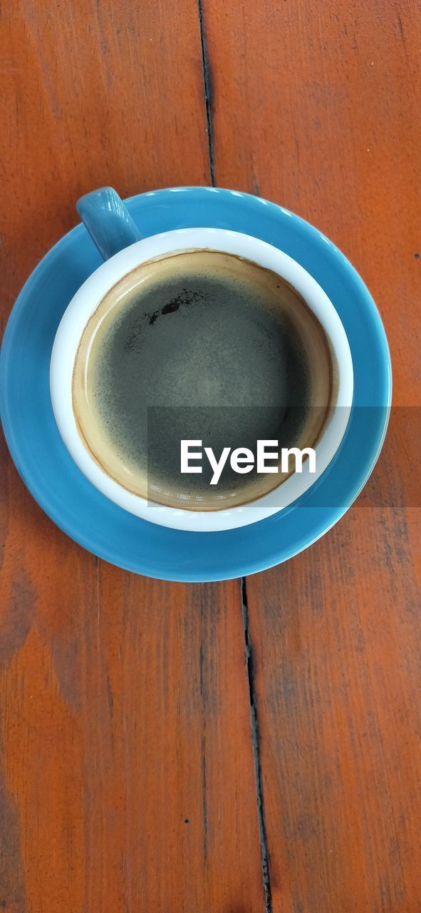 cup, drink, mug, food and drink, refreshment, coffee, wood, coffee cup, table, crockery, hot drink, blue, directly above, saucer, no people, indoors, still life, high angle view, freshness, tea, close-up, ceramic, tableware