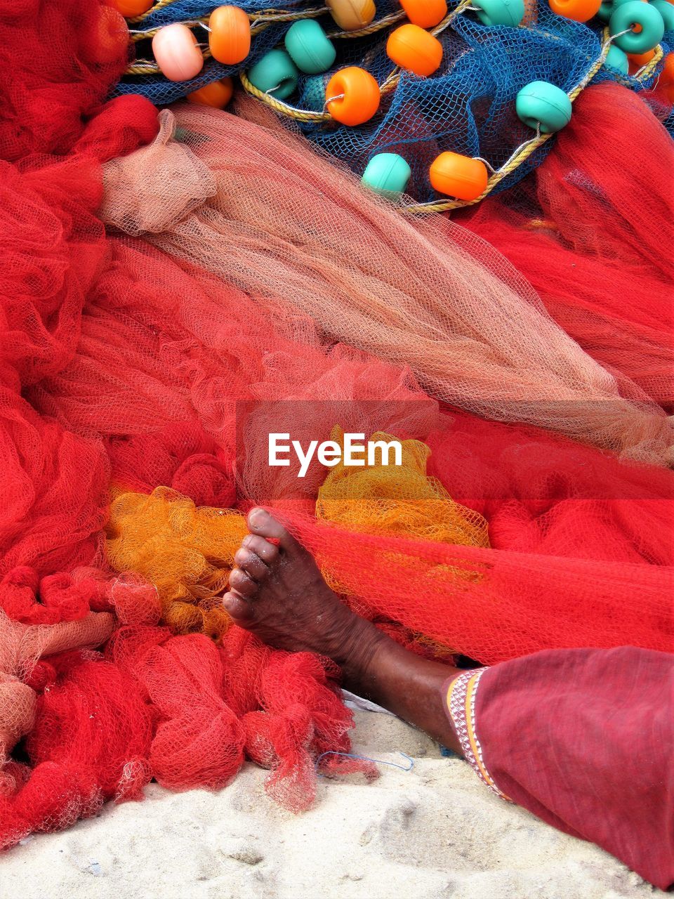 High angle view of woman among colorful textiles