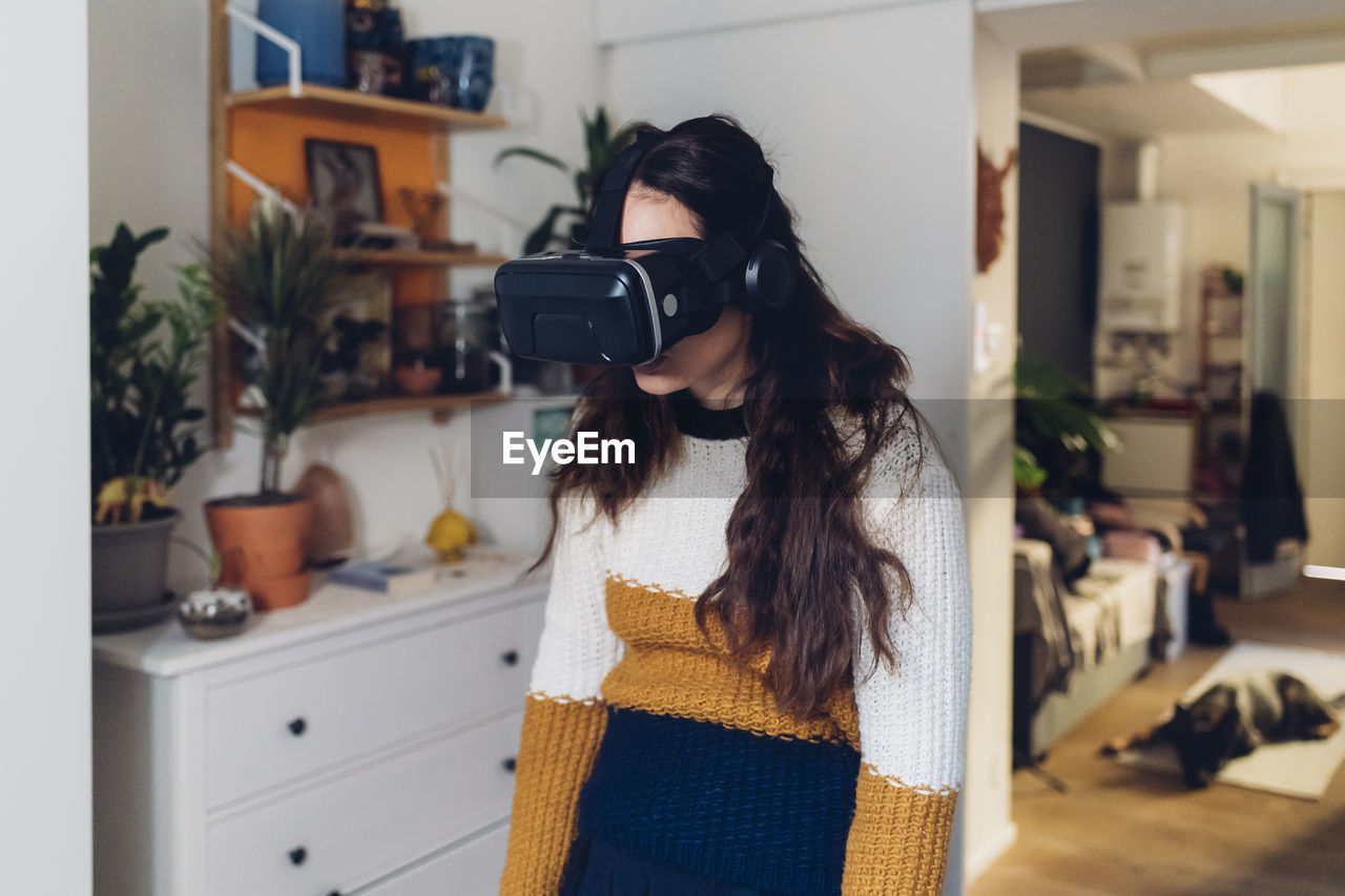 Tired woman with virtual reality headset at home