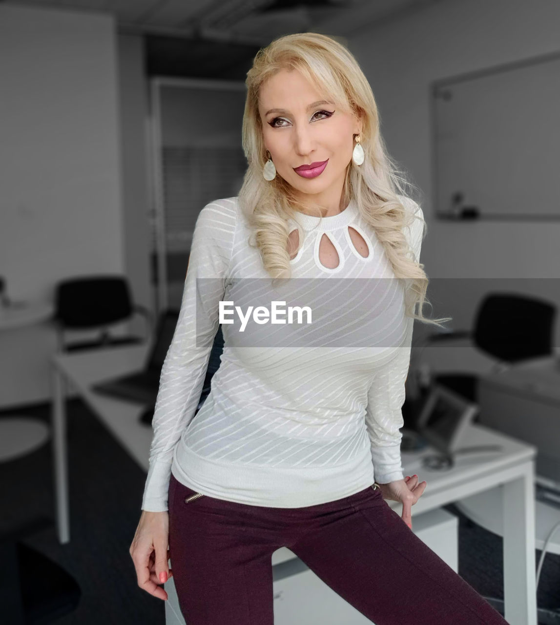 Portrait of beautiful woman looking away while sitting at office