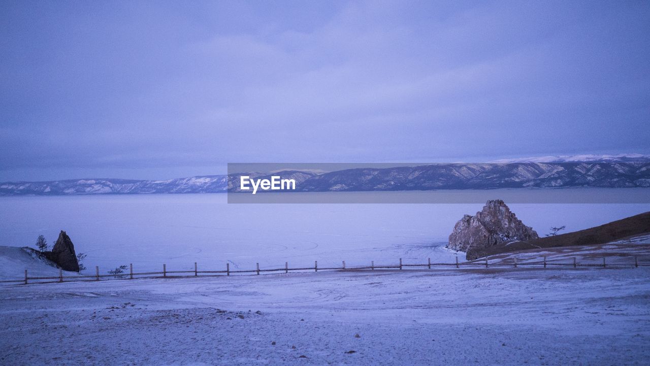 Scenic view of snow covered mountains against sky
