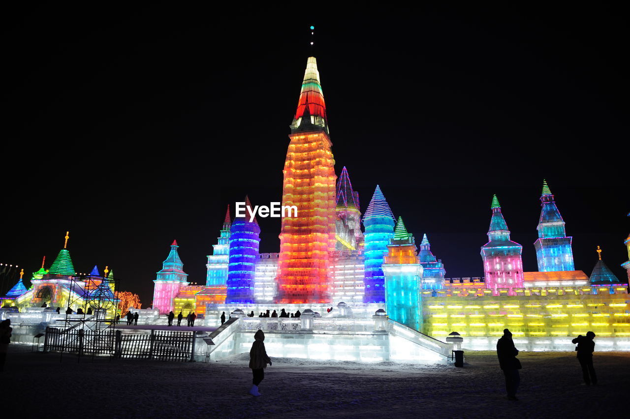 VIEW OF ILLUMINATED TEMPLE AT NIGHT