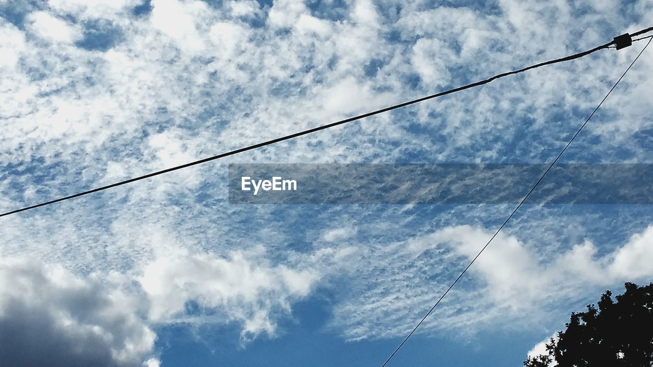 LOW ANGLE VIEW OF POWER LINES AGAINST CLOUDY SKY