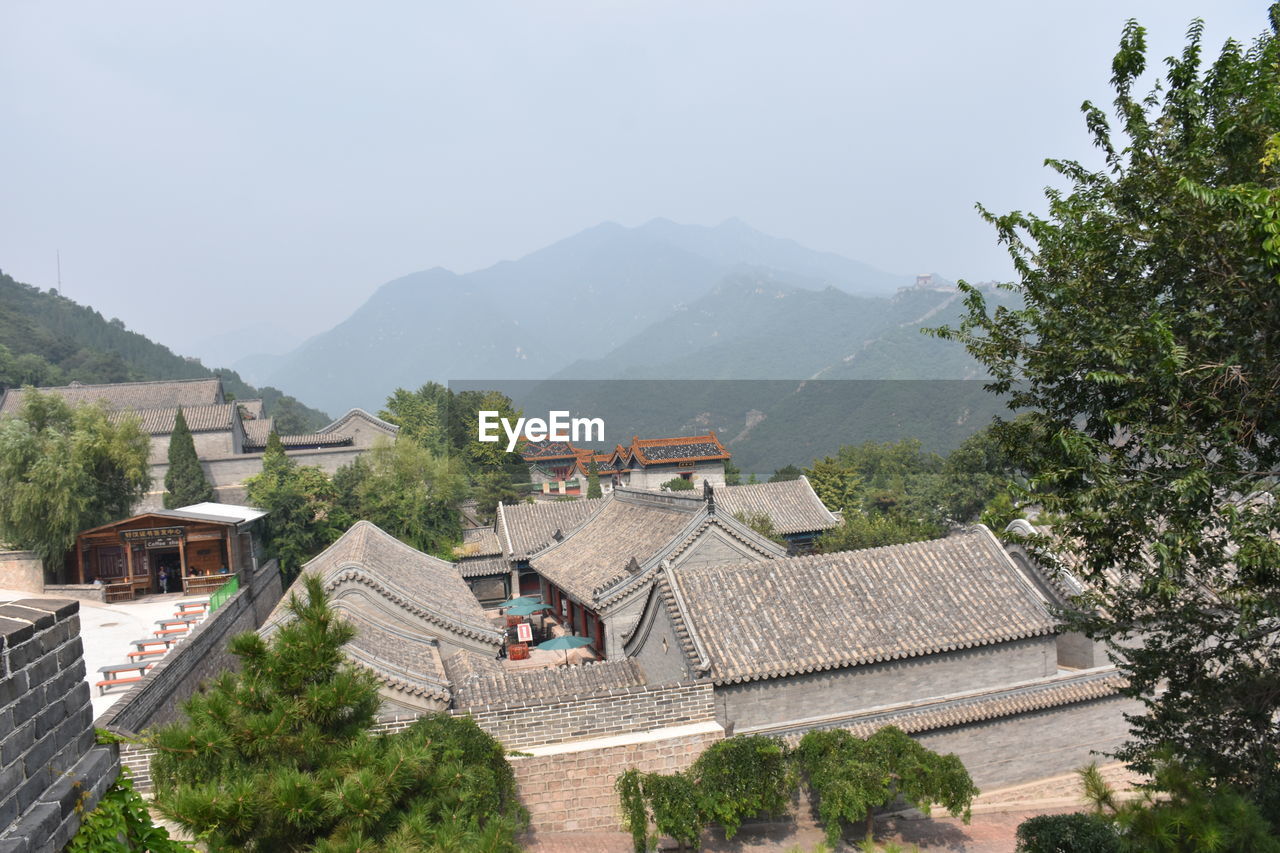 High angle view of houses and mountains against sky