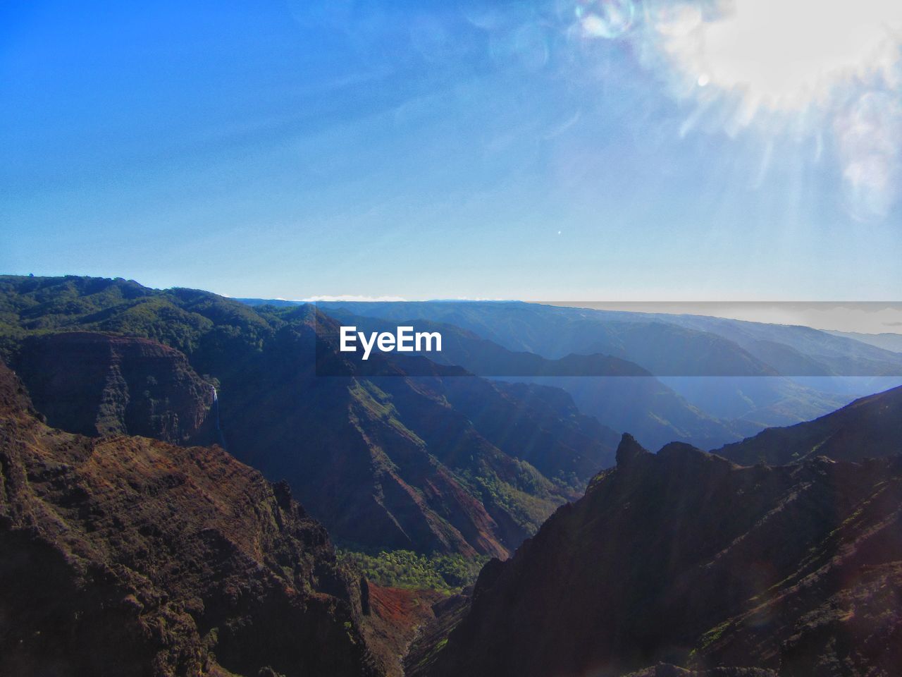 PANORAMIC SHOT OF MOUNTAINS AGAINST BLUE SKY