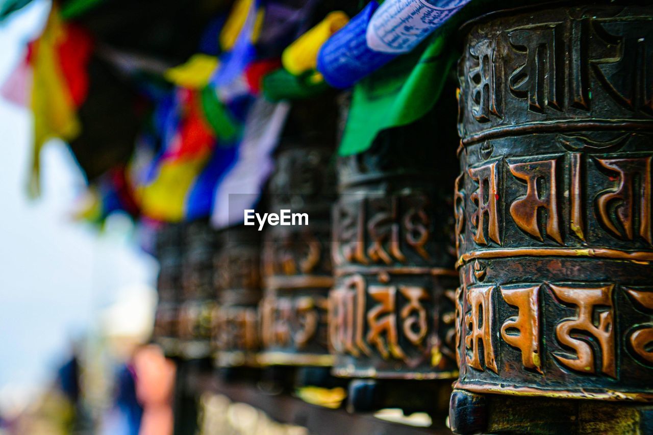 religion, belief, tradition, spirituality, temple - building, architecture, multi colored, travel destinations, craft, focus on foreground, no people, market, history, travel, place of worship, close-up, outdoors, city, tourism, day, business finance and industry, building, the past