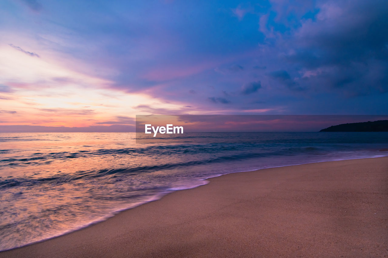 A colorful seascape with a vivid sky background