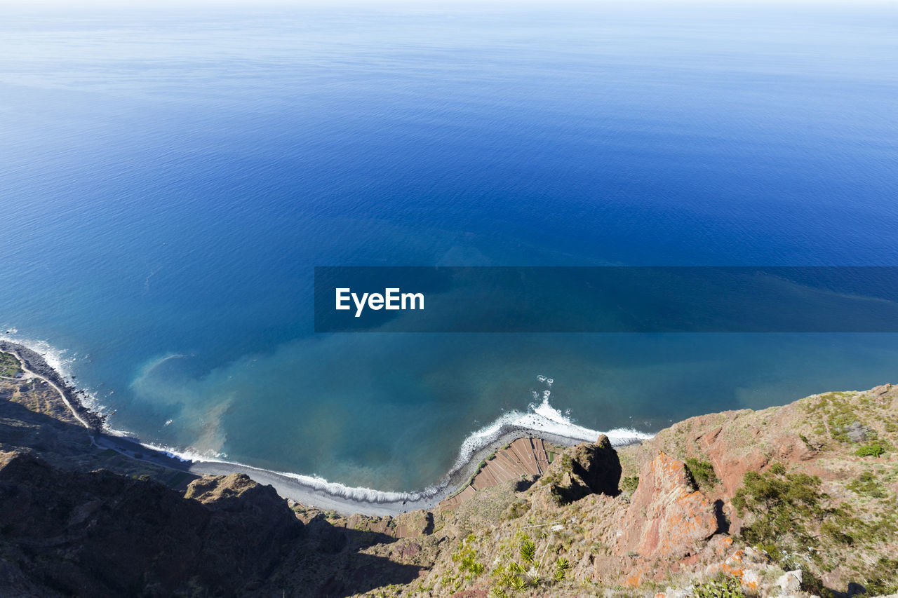 High angle view of sea and mountain against sky