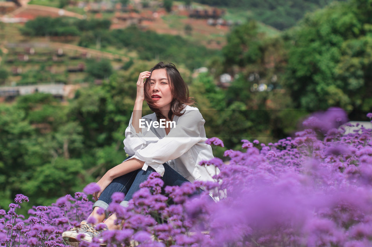 YOUNG WOMAN WITH PINK FLOWERS