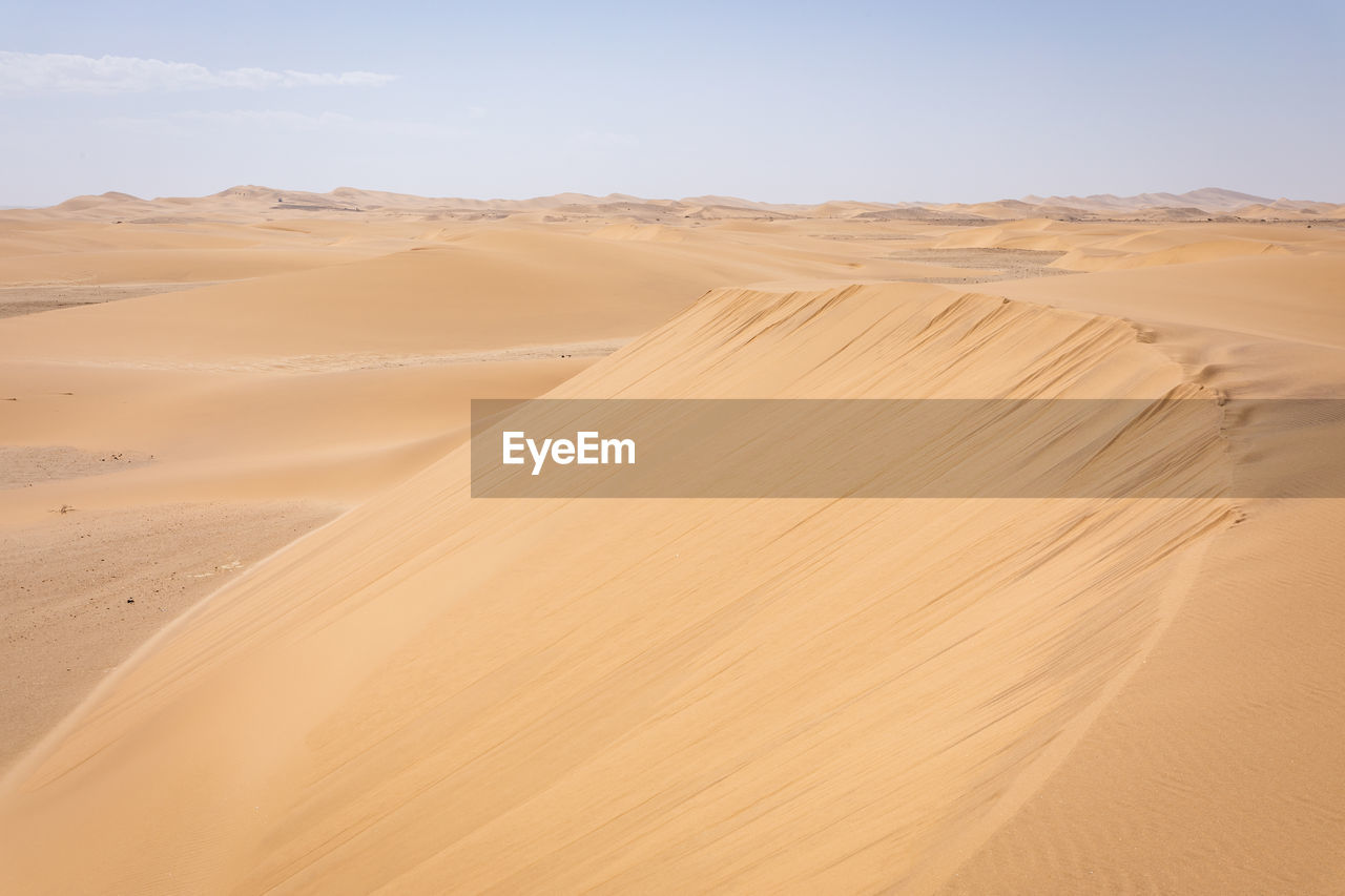 scenic view of sand dunes in desert against sky