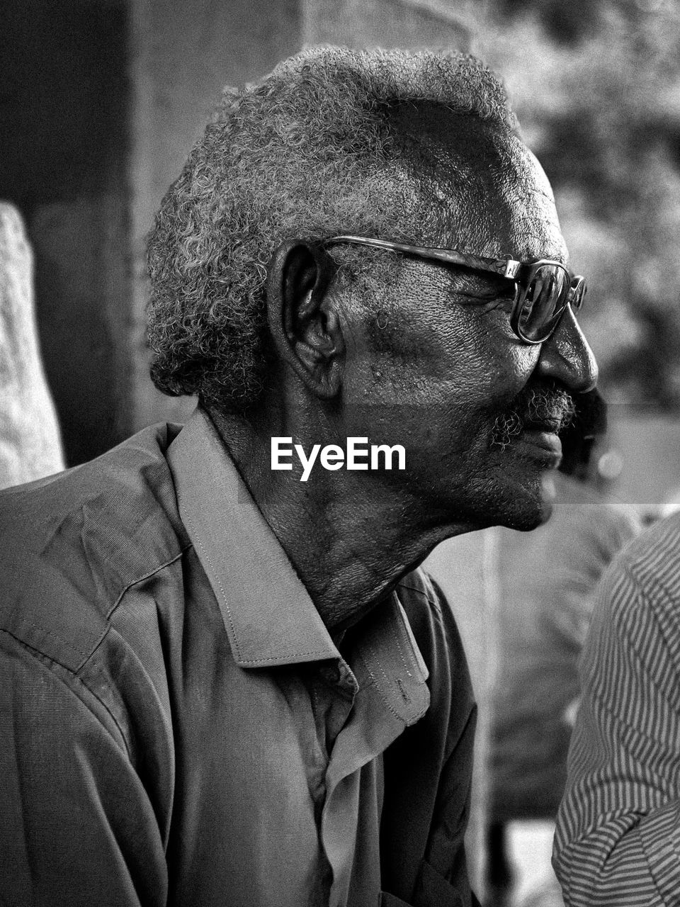 Close-up portrait of old man looking away