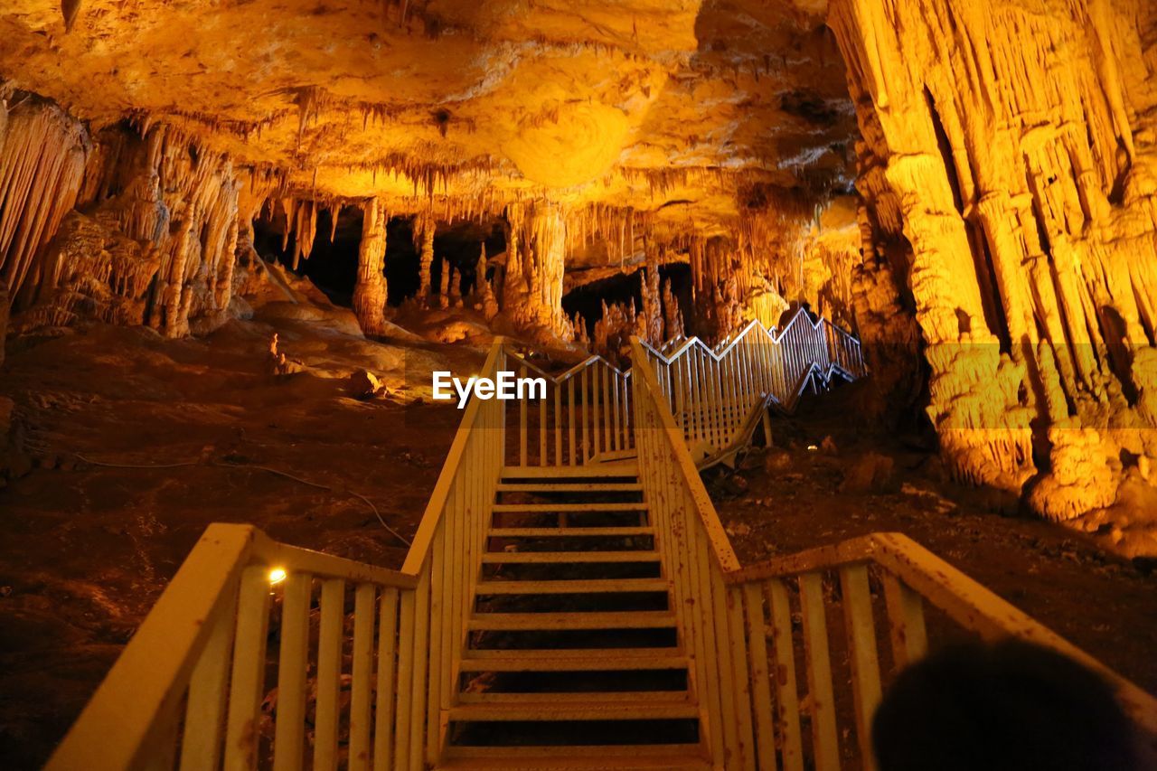 Low angle view of steps in illuminated cave