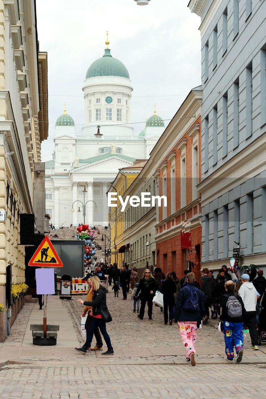 People on street with helsinki cathedral in background