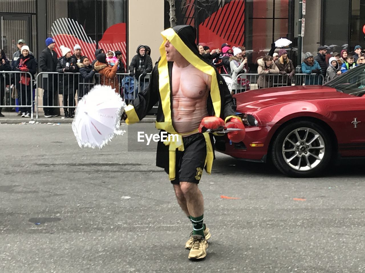 REAR VIEW OF MAN AND WOMAN WALKING ON STREET