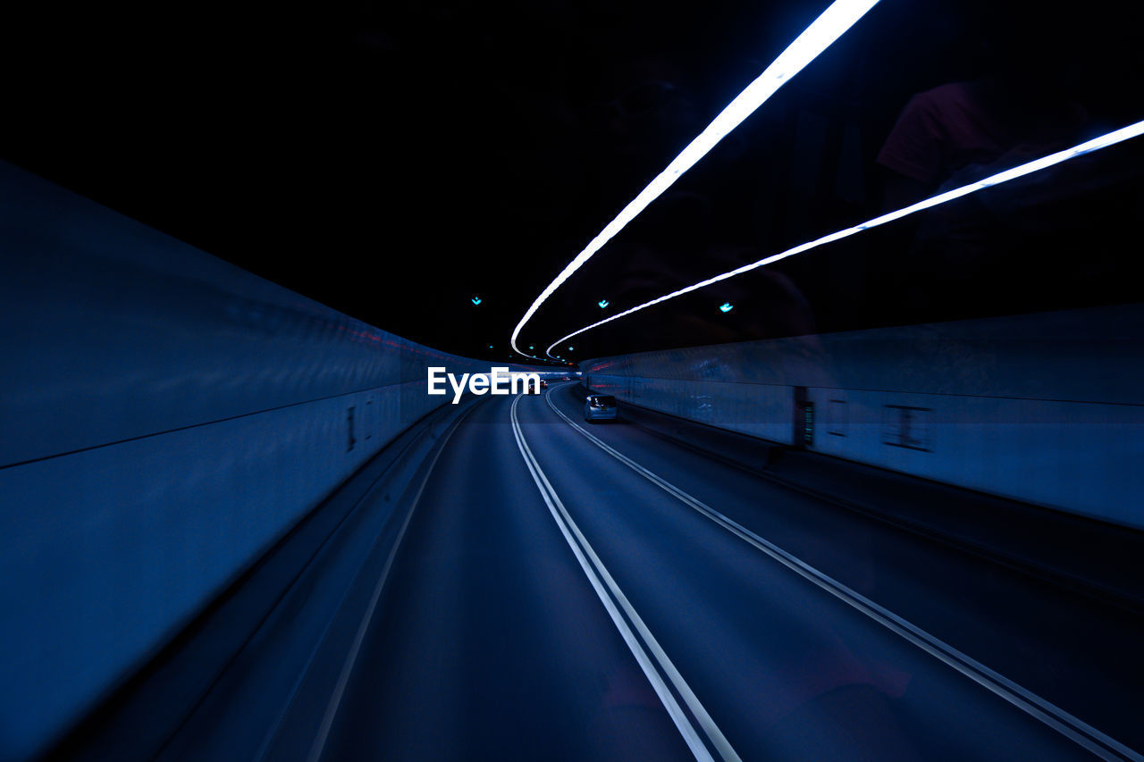 LIGHT TRAILS ON ROAD AT NIGHT