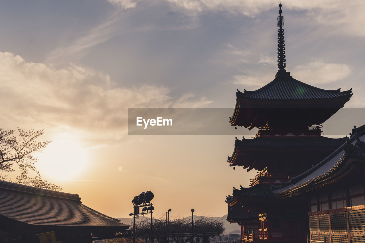 Low angle view of pagoda against sky during sunset