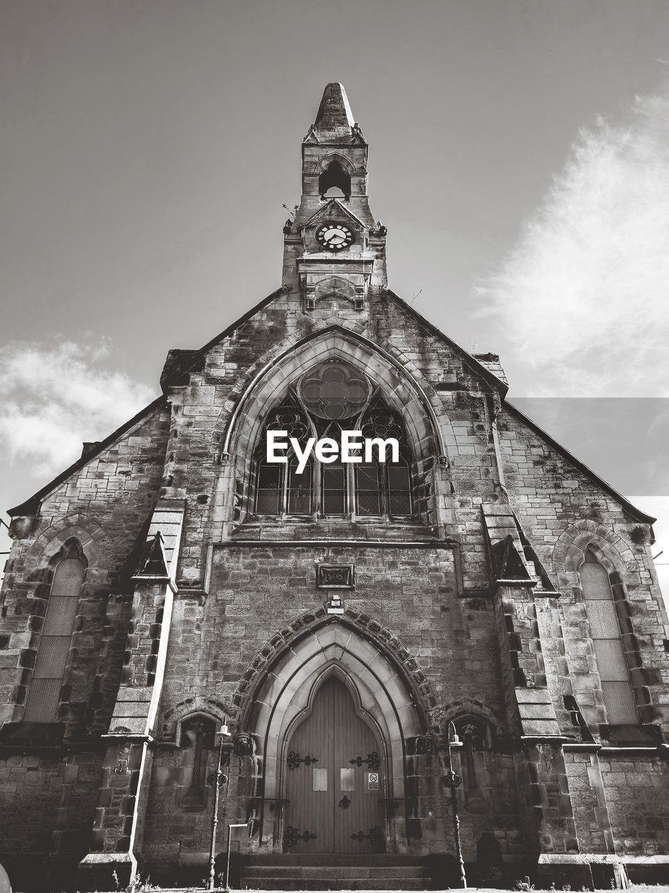 LOW ANGLE VIEW OF CATHEDRAL AGAINST CLOUDY SKY