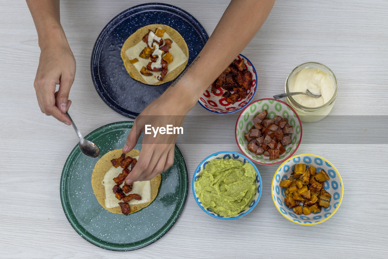 Woman serving mexican tacos high angle view