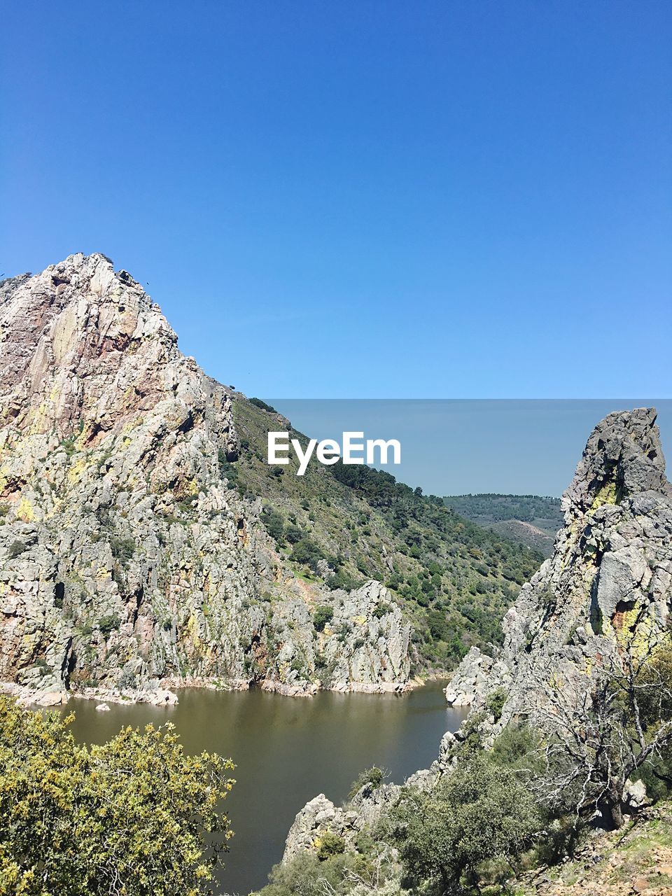 Scenic view of mountains against clear blue sky