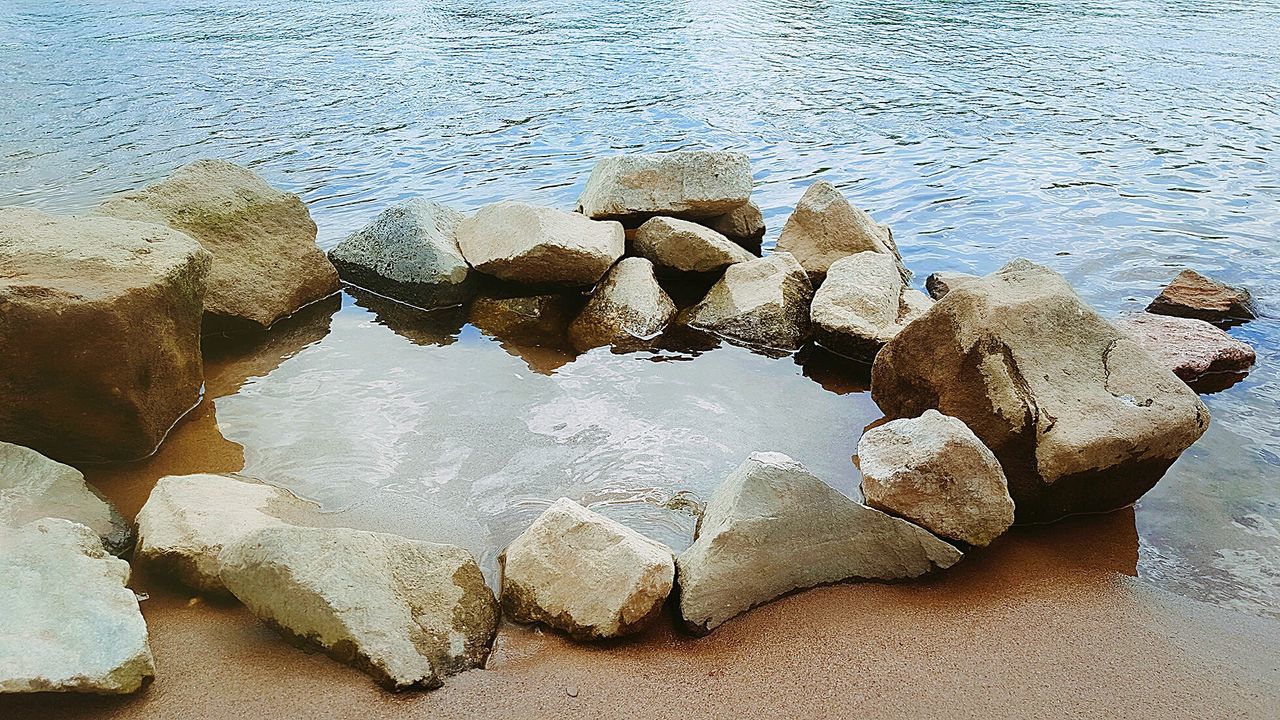 High angle view of rocks on sea shore